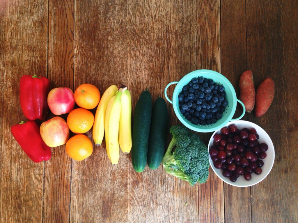 Rainbow of fruits and vegetables on a wooden table